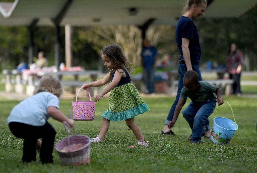 Small children helping each other outdoors